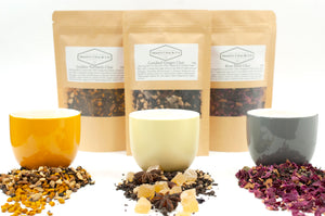 Shanti Chai & Co's specialty chai blends: Golden Turmeric Chai, Candied Ginger Chai and Rose Petal Chai. Three specialty chai against three chai cups. 
