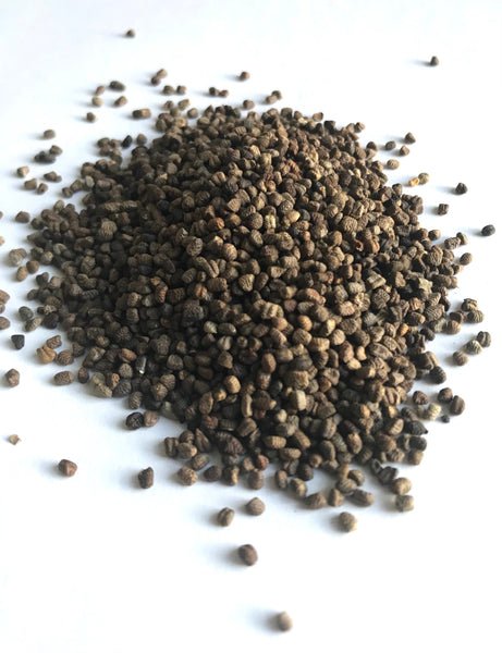 Cardamom seeds against a white background.
