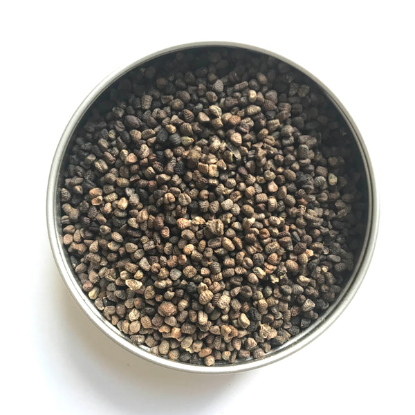 Cardamom seeds in a tin.